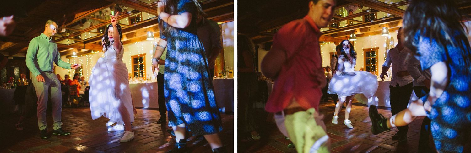 Wedding celebration with dynamic dancing and white dress twirling in a decorated venue.