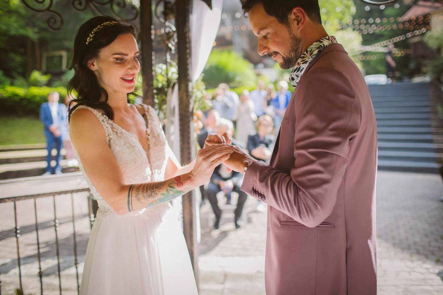 An emotional exchange of rings during an outdoor wedding ceremony.