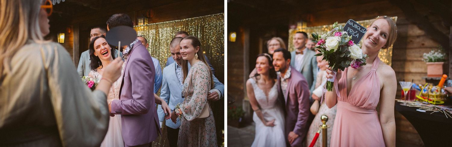 Wedding guests mingle and laugh during an indoor reception with gold decor.