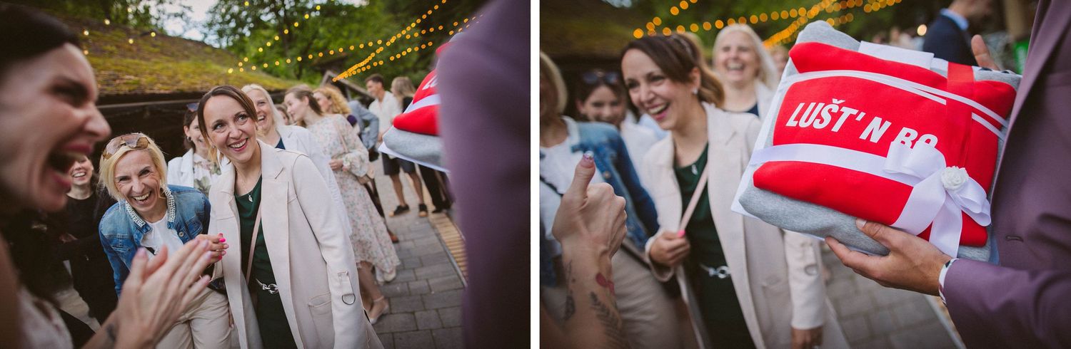 Party guests celebrate with a red and white striped prop at an outdoor event.