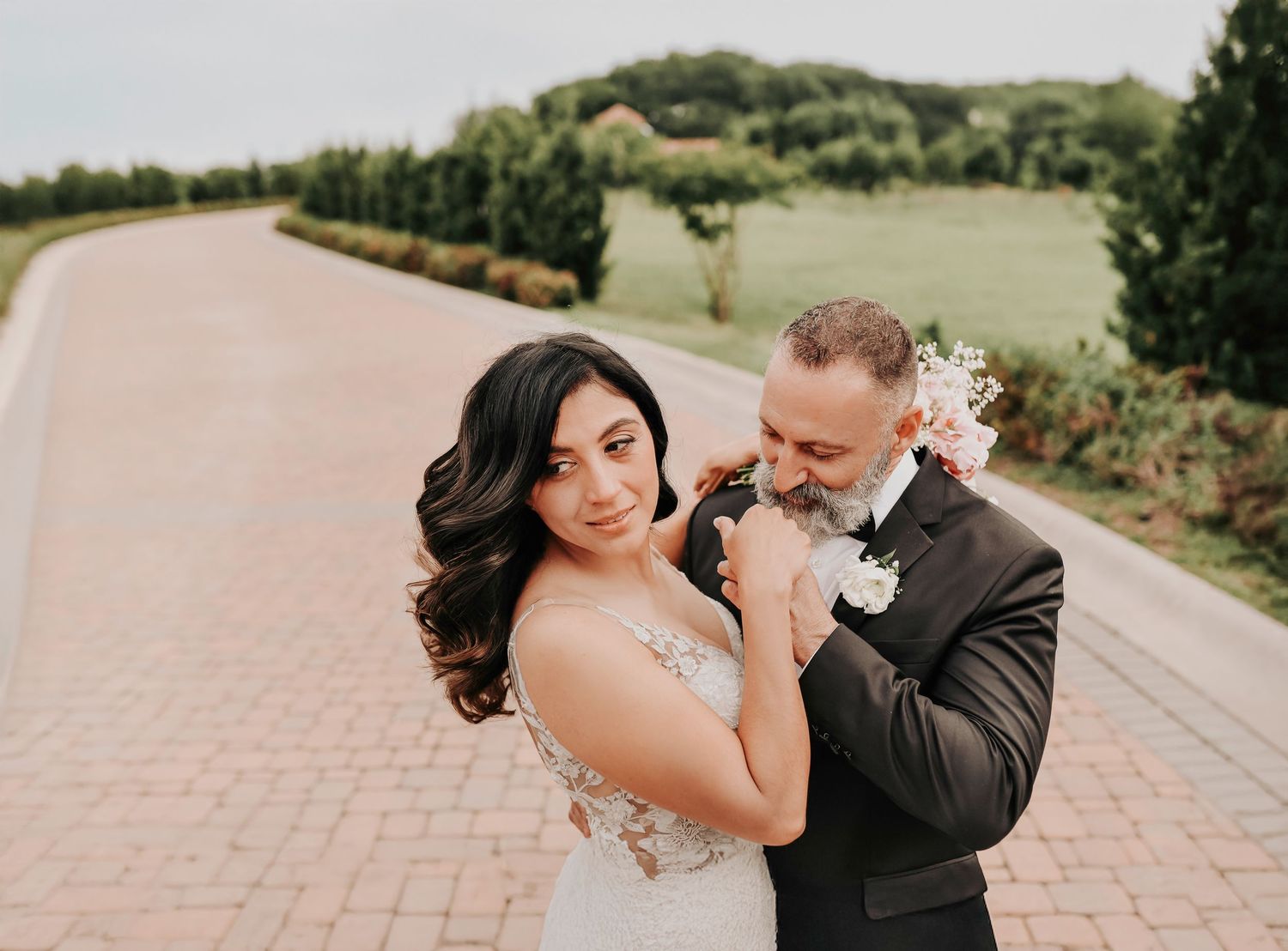 romantic wedding photo of a bride and groom posing for their wedding photos at their venue in McKinney Texas by april pinto photographer