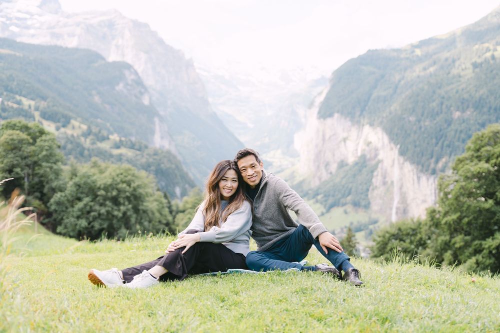 Couple enjoying a romantic moment in the Swiss Alps with majestic mountain peaks in the background near Interlaken in Wengen.