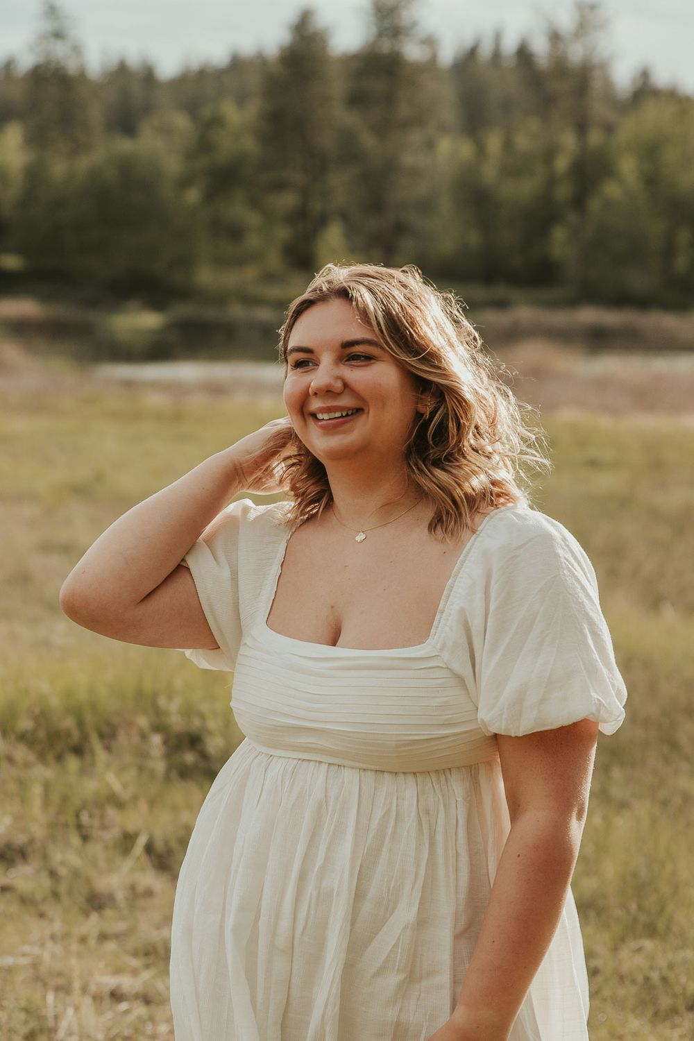 Close-up of smiling Class of 2025 senior from Davenport High School during golden hour senior session in field near Spokane at rustic venue