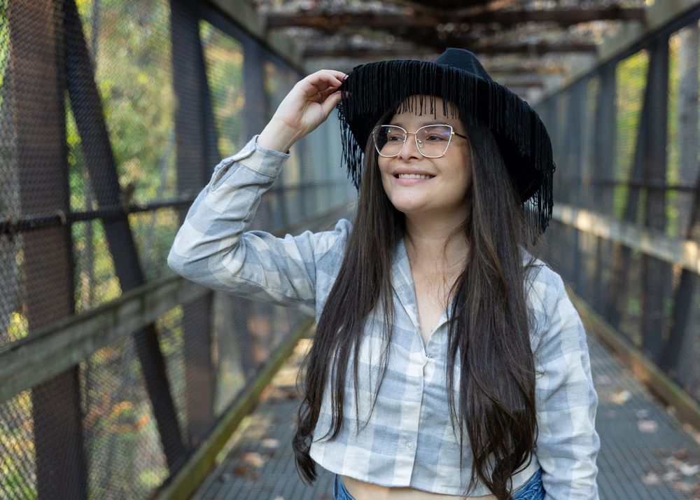 girl smiling on pedestrian bridge in autumn — lifestyle portrait photography