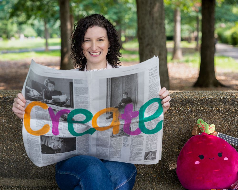 Creative lifestyle portrait holding newspaper with colorful lettering — storytelling portrait photography