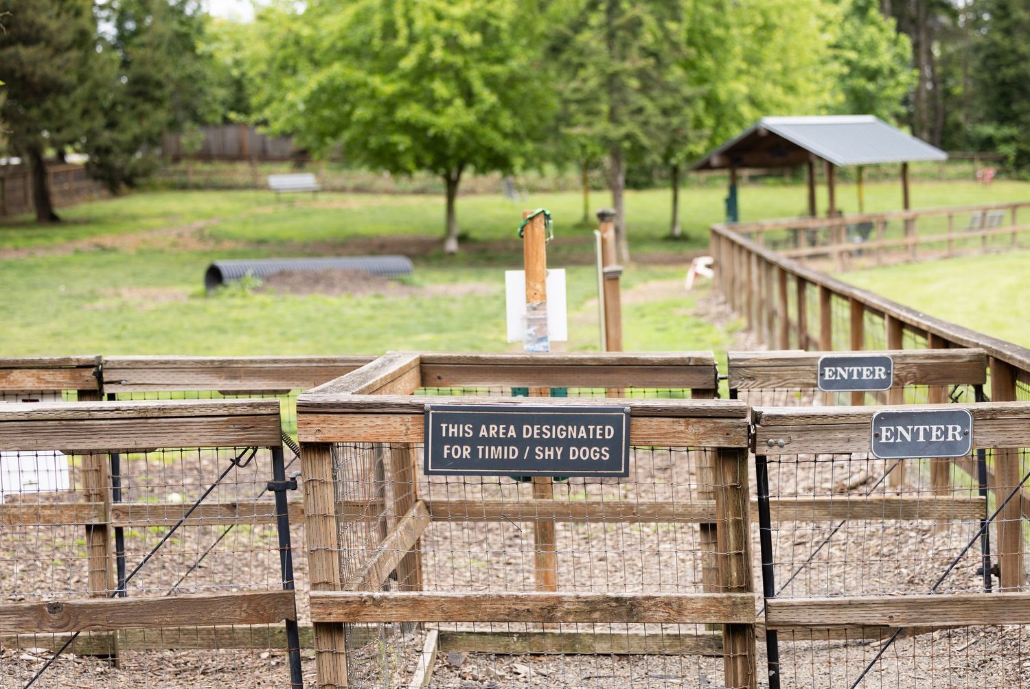 Small, shy dog park at Hazelia Field in Lake Oswego Oregon. Covered seating, tunnels, water features, and double-gated entry.