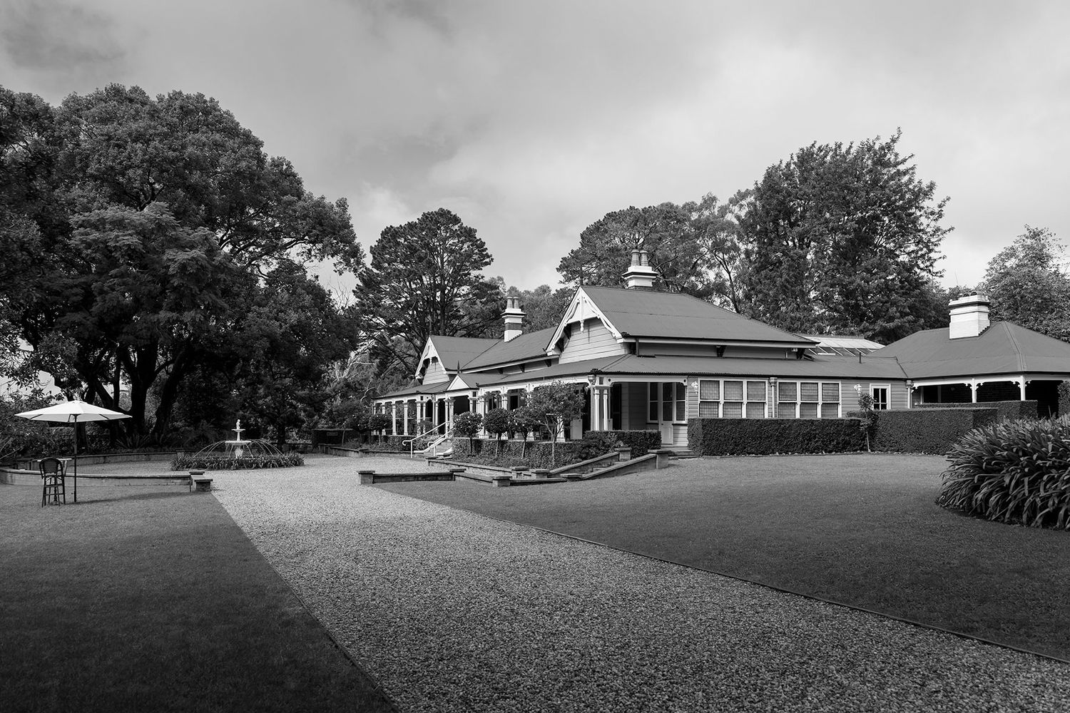 A black and white panoramic view of historic Gabbinbar Homestead in Toowoombar Queensland on a cloudy day.