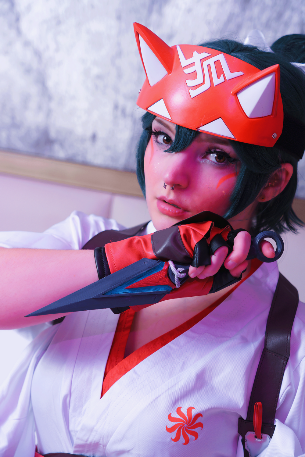 Kashi Cosplay as Kiriko from Overwatch, with a kunai braced and ready to use against the viewer