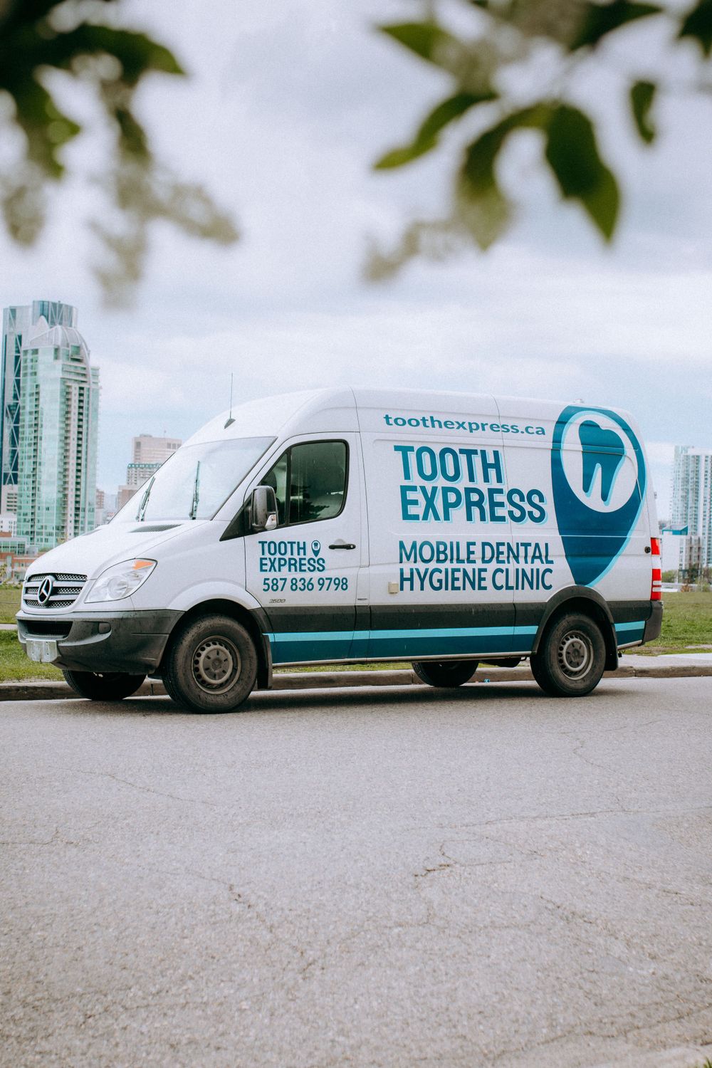 Fleet of white Tooth Express mobile dental hygiene clinic vans parked in a row.