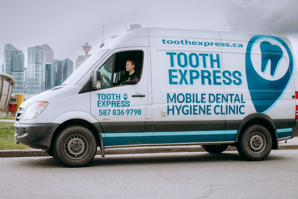 Mobile dental hygiene clinic van with Tooth Express branding and contact information.