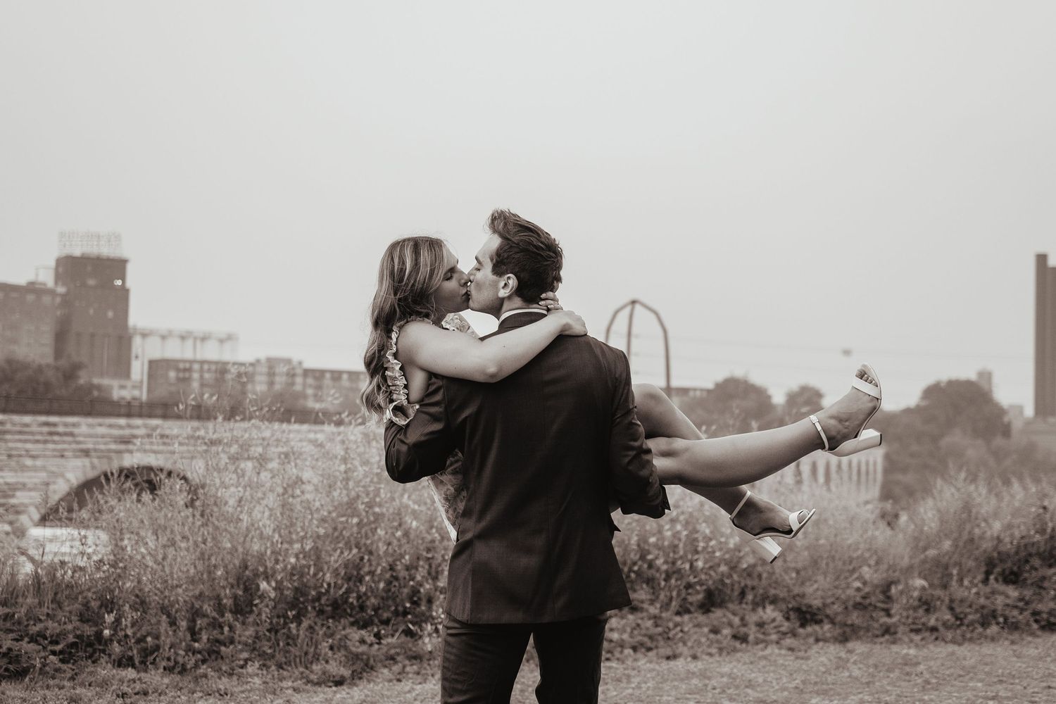 A black and white photo collage showing five romantic couple scenes in outdoor settings.