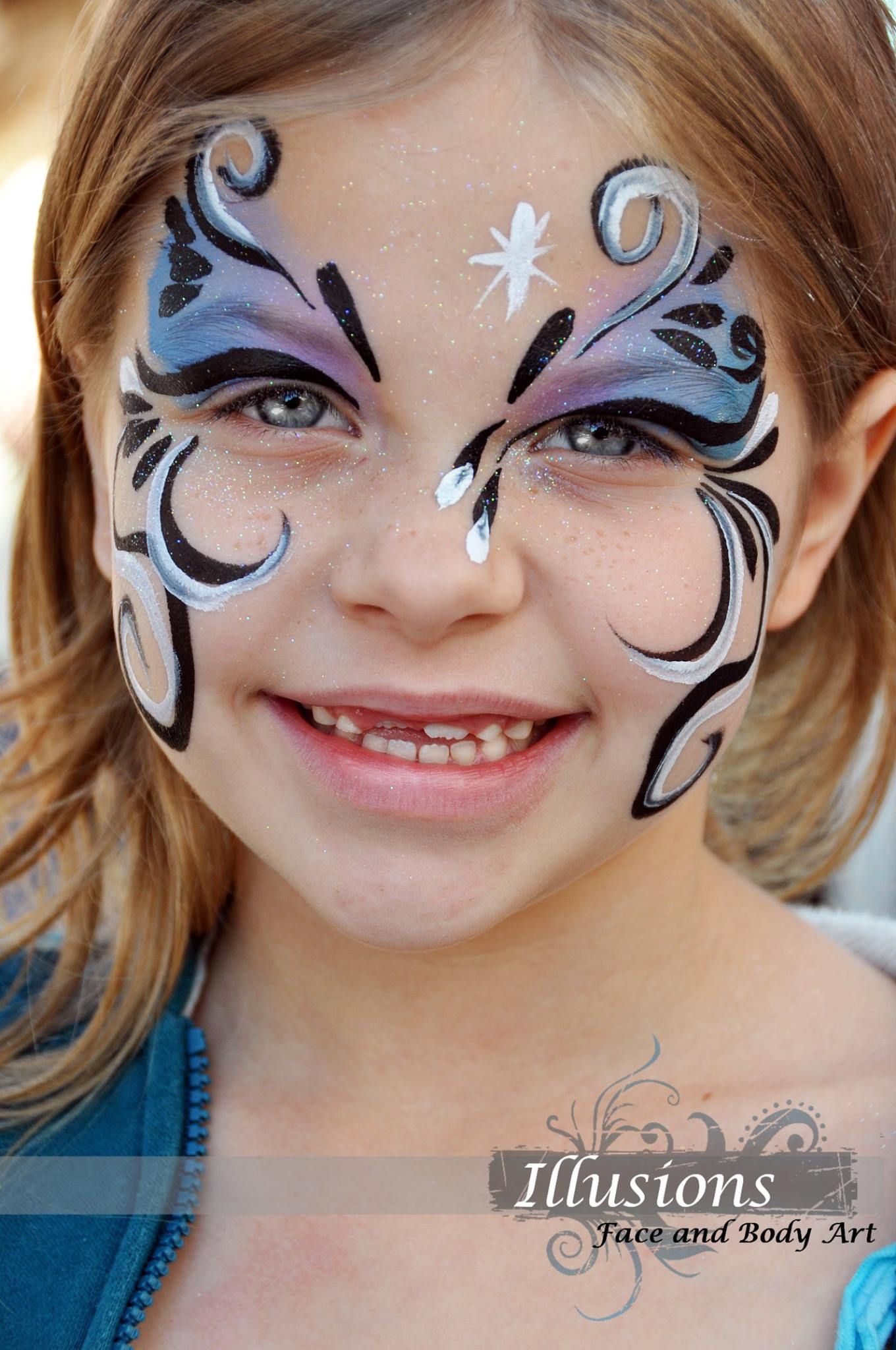 Elegant black and white swirl face paint design with star accent.