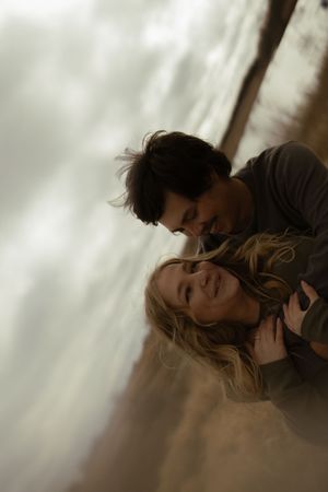 A close-up shot captures an intimate moment between two people.