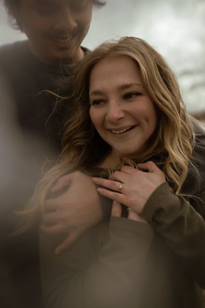 A romantic close-up portrait of a couple embracing with soft lighting and dreamy atmosphere.