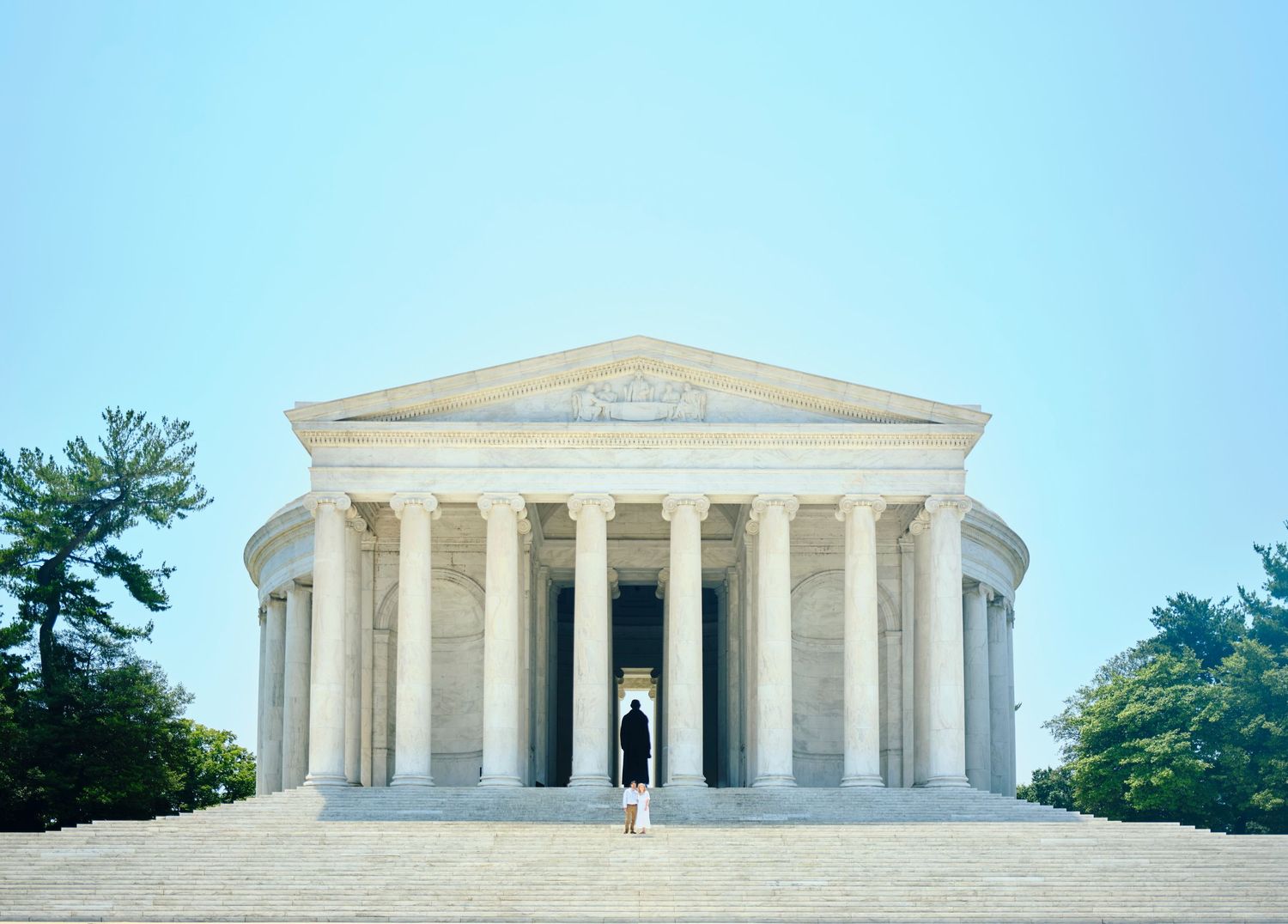 Formal engagement portrait of couple standing at the Jefferson Memorial in Washington D.C.