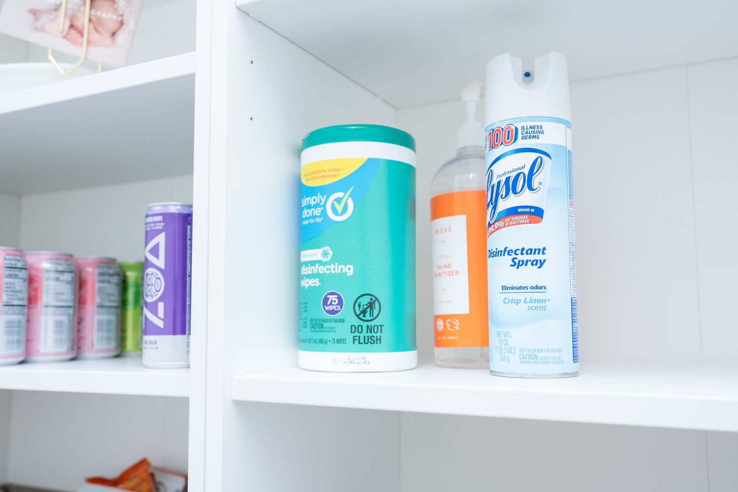 White shelving unit displaying cleaning supplies and household products.