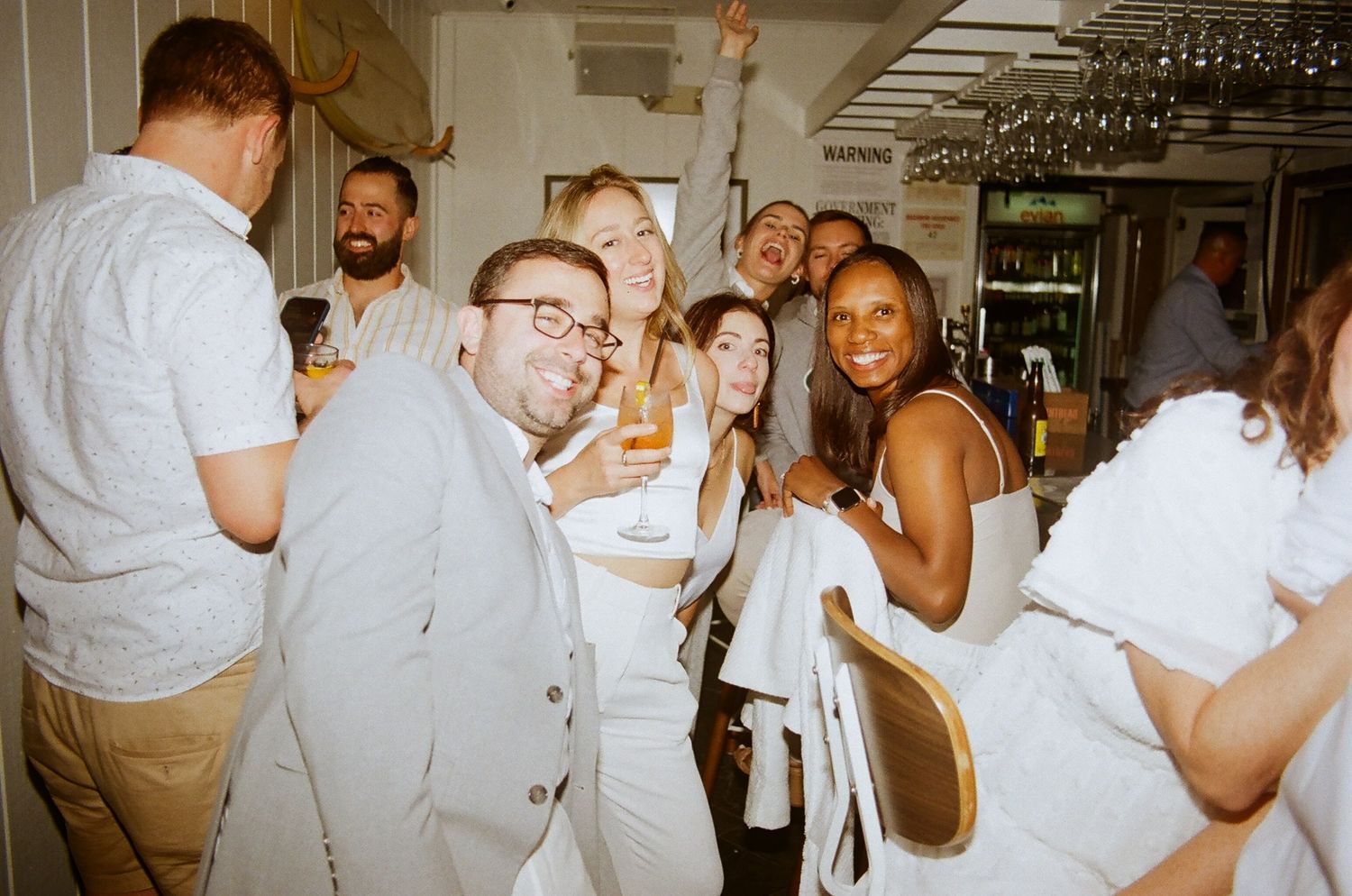 People celebrating and dancing at a lively indoor party or reception.