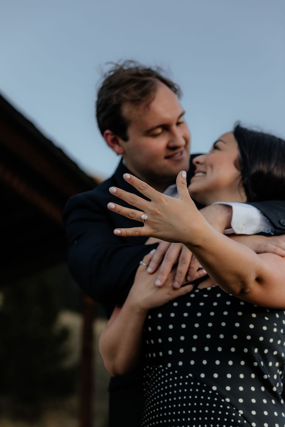 A romantic engagement photoshoot sequence shows a couple embracing while wearing black and polka dot clothing outdoors.