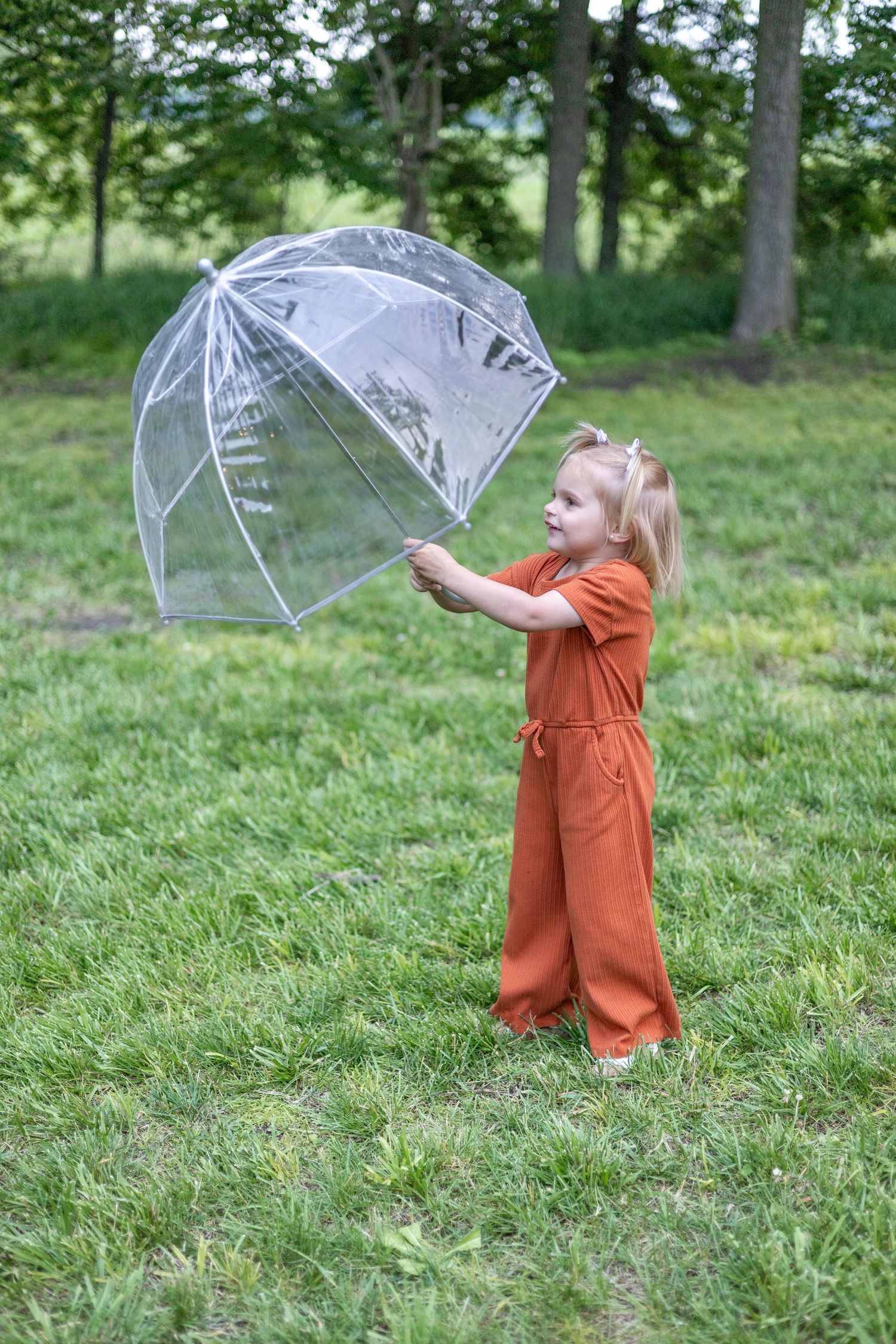 Springfield Illinois photographer captures a young girl playing with an umbrella during a photo session in Central Illinois