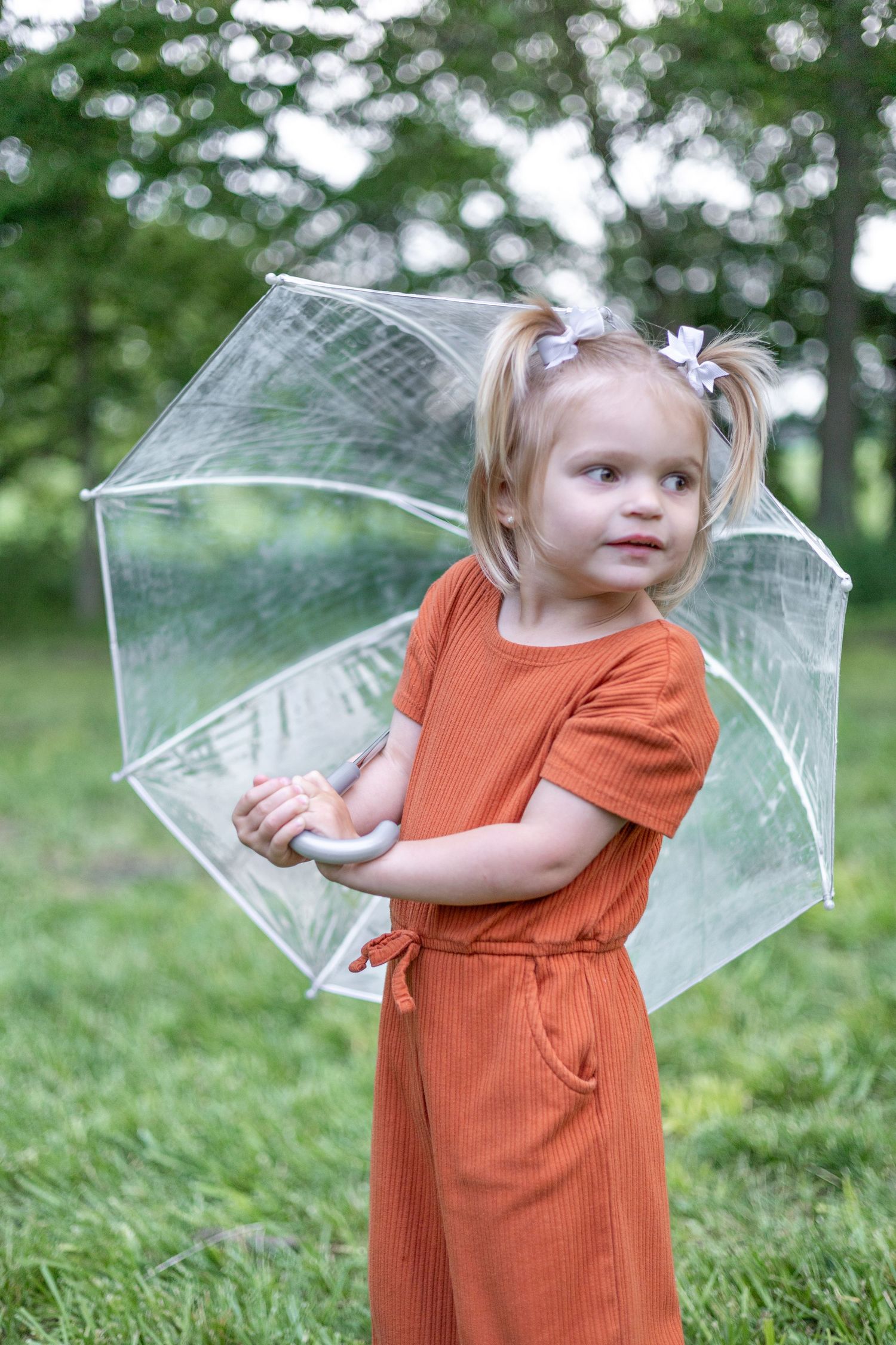 Springfield Illinois photographer captures a young girl smiling with an umbrella during a photo session in Central Illinois