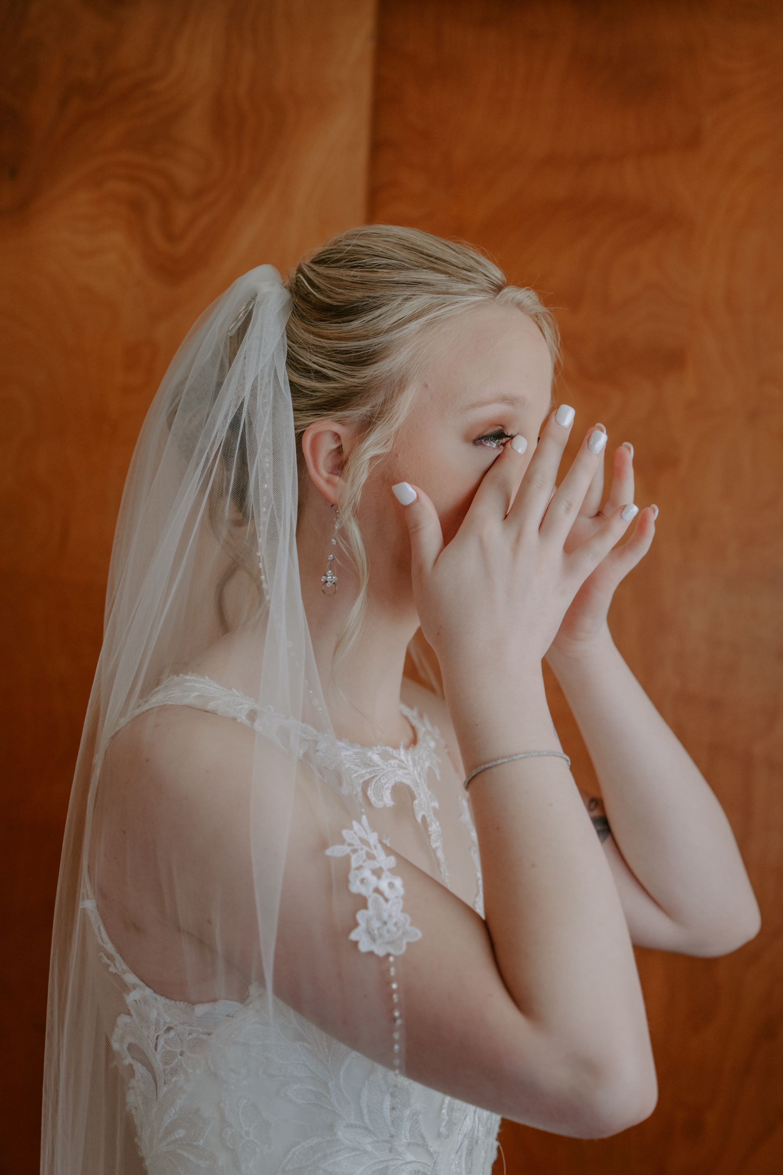 Close-up sequence of bride in white veil against brown background showing emotional reaction.