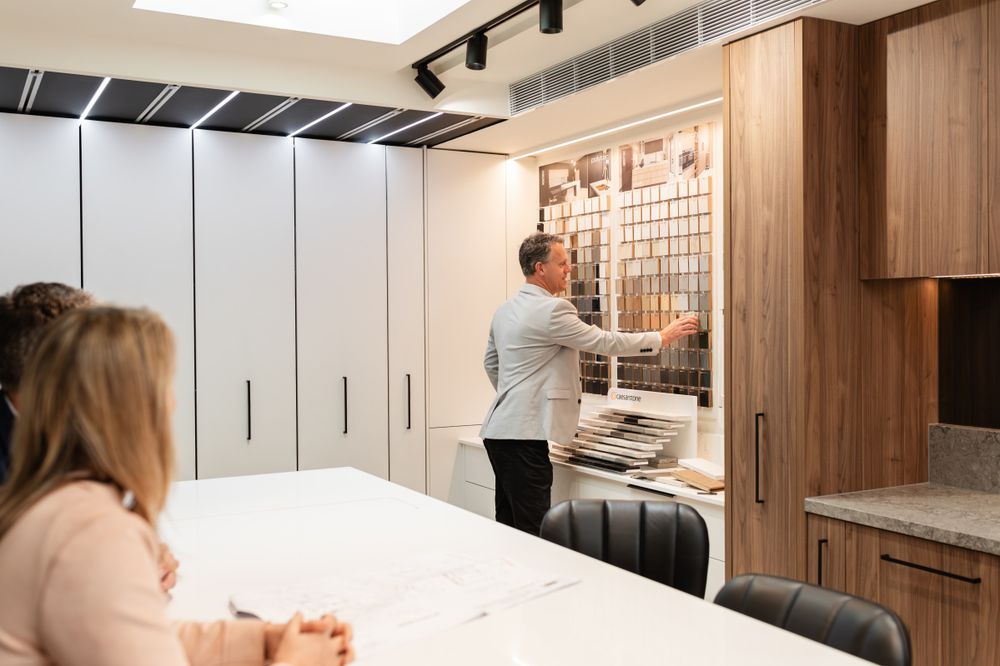 Modern office kitchen design consultation with material samples on display.