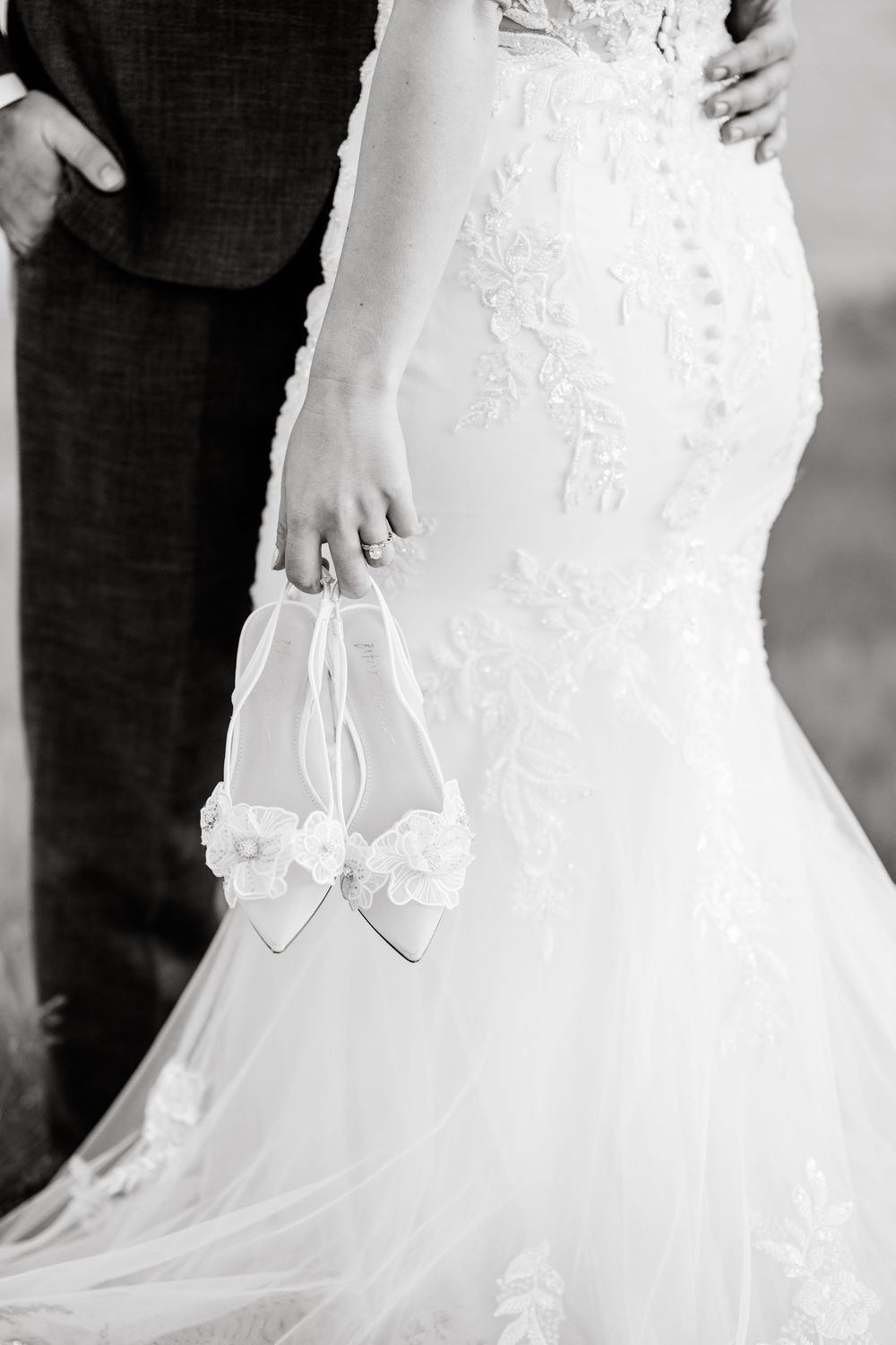 Close-up detail shots of a flowing white lace wedding dress against a light background.