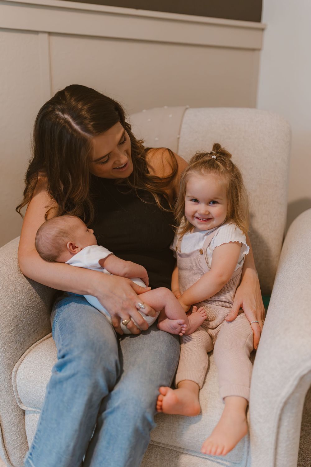 A touching photo series showing tender moments between a parent and child sitting on a white couch, with warm lighting.