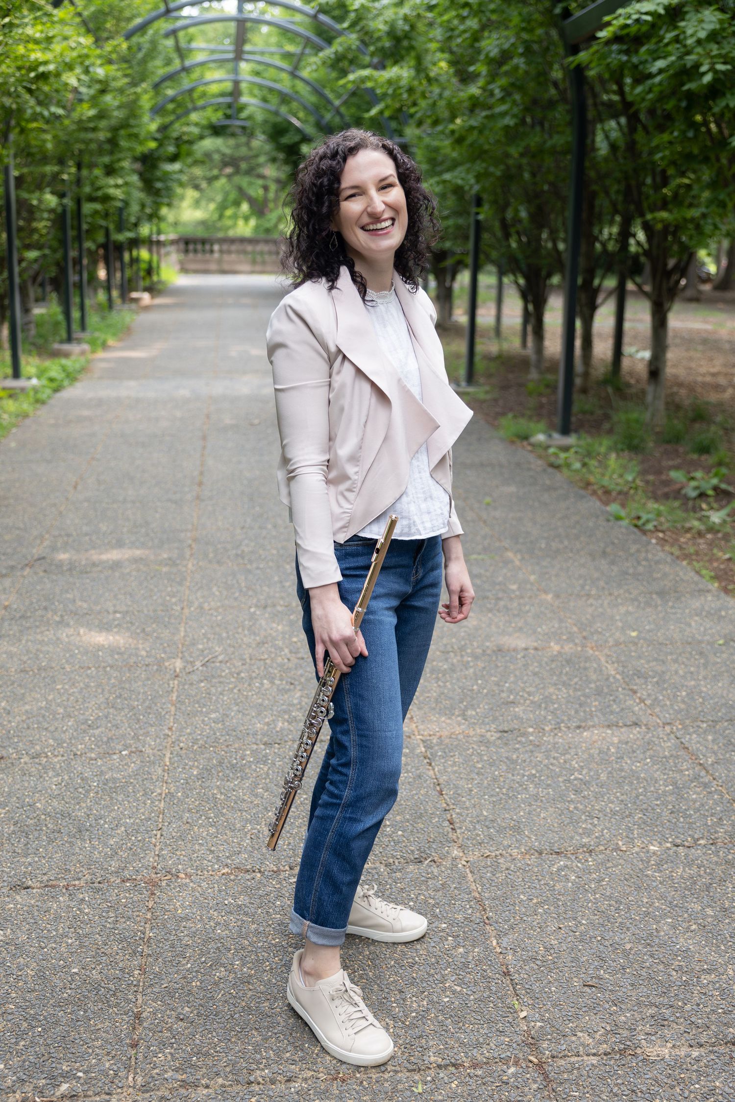 Portrait of flutist holding instrument on park path — musician lifestyle photography