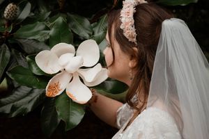 Elegant white wedding bouquet with magnolia flowers and greenery photographed from multiple angles.
