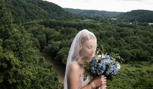 A scenic mountain landscape view at an outdoor wedding venue with lush green forest surroundings.