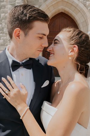 Romantic close-up photos of a couple in formal wedding attire sharing intimate kisses and tender moments.