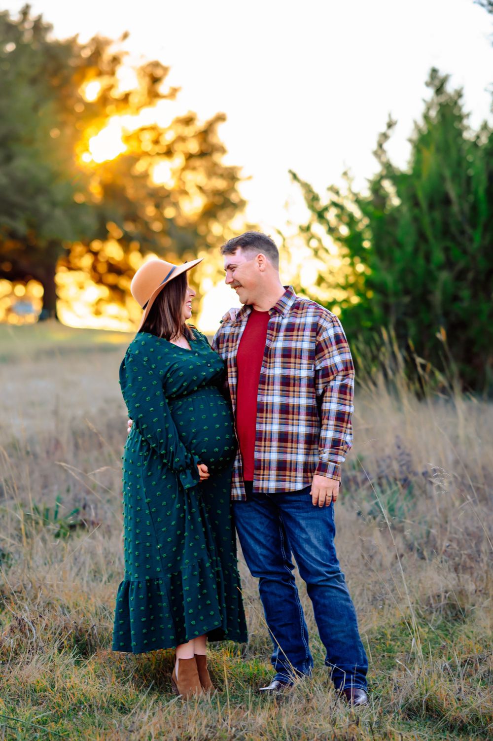 Forney couple stands looking at each other during white rock lake maternity photo session at sunset dallas by mesquite family photographer