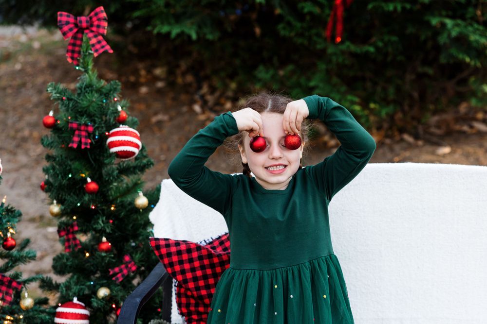 Holiday scene with decorated Christmas tree, red ornaments, and buffalo plaid decor.