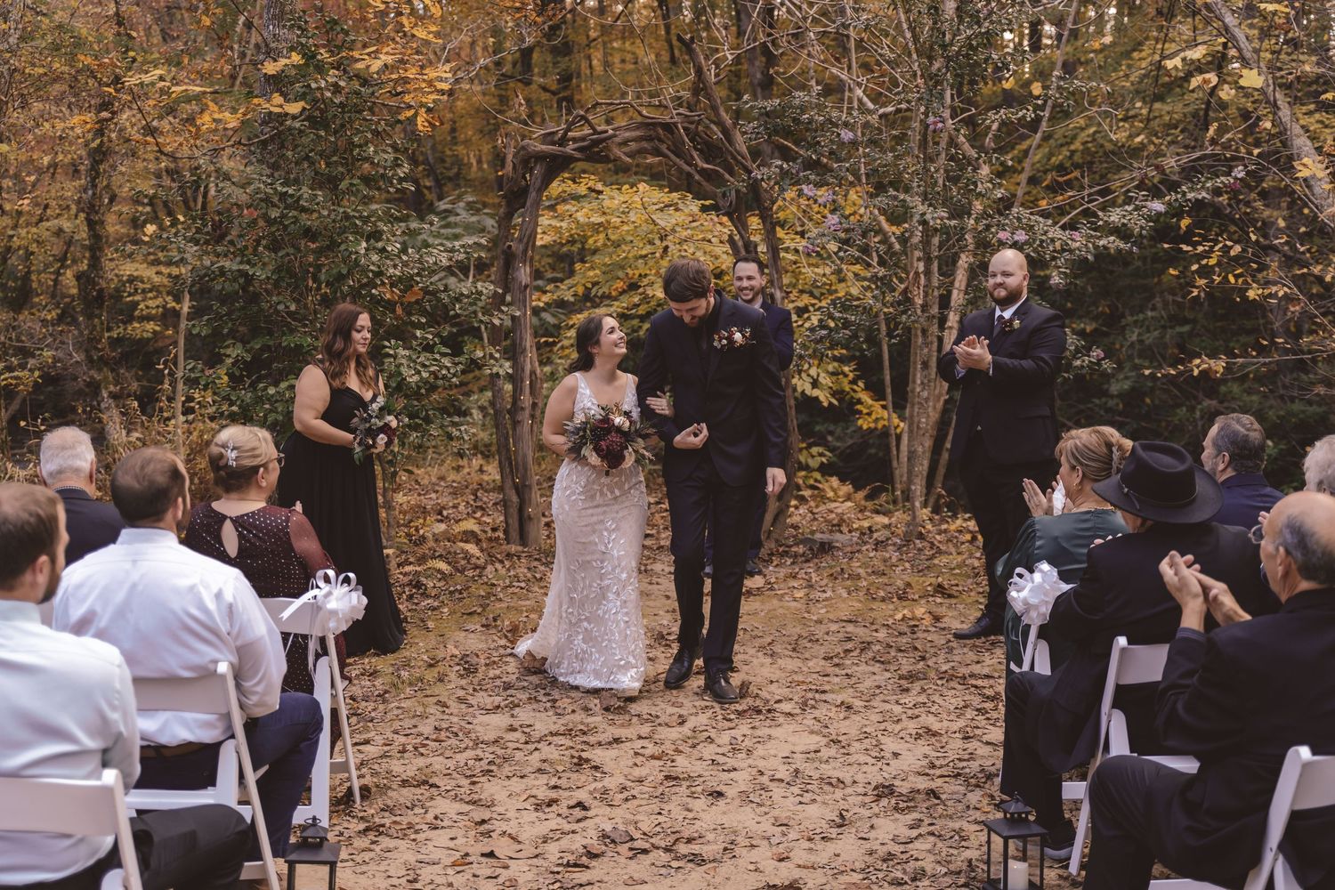 Newlyweds exiting the aisle during the wedding ceremony at Elkin Creek Vineyard in Elkin, NC