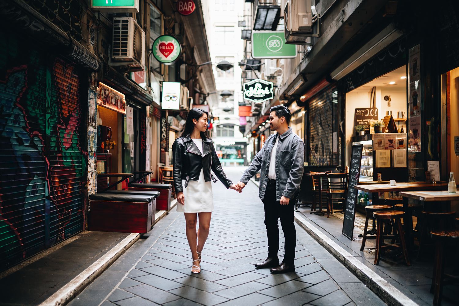 Melbourne photographer Pei A Photography capturing a casual couple holding hands at the iconic Hosier Lane for their engagement photos.