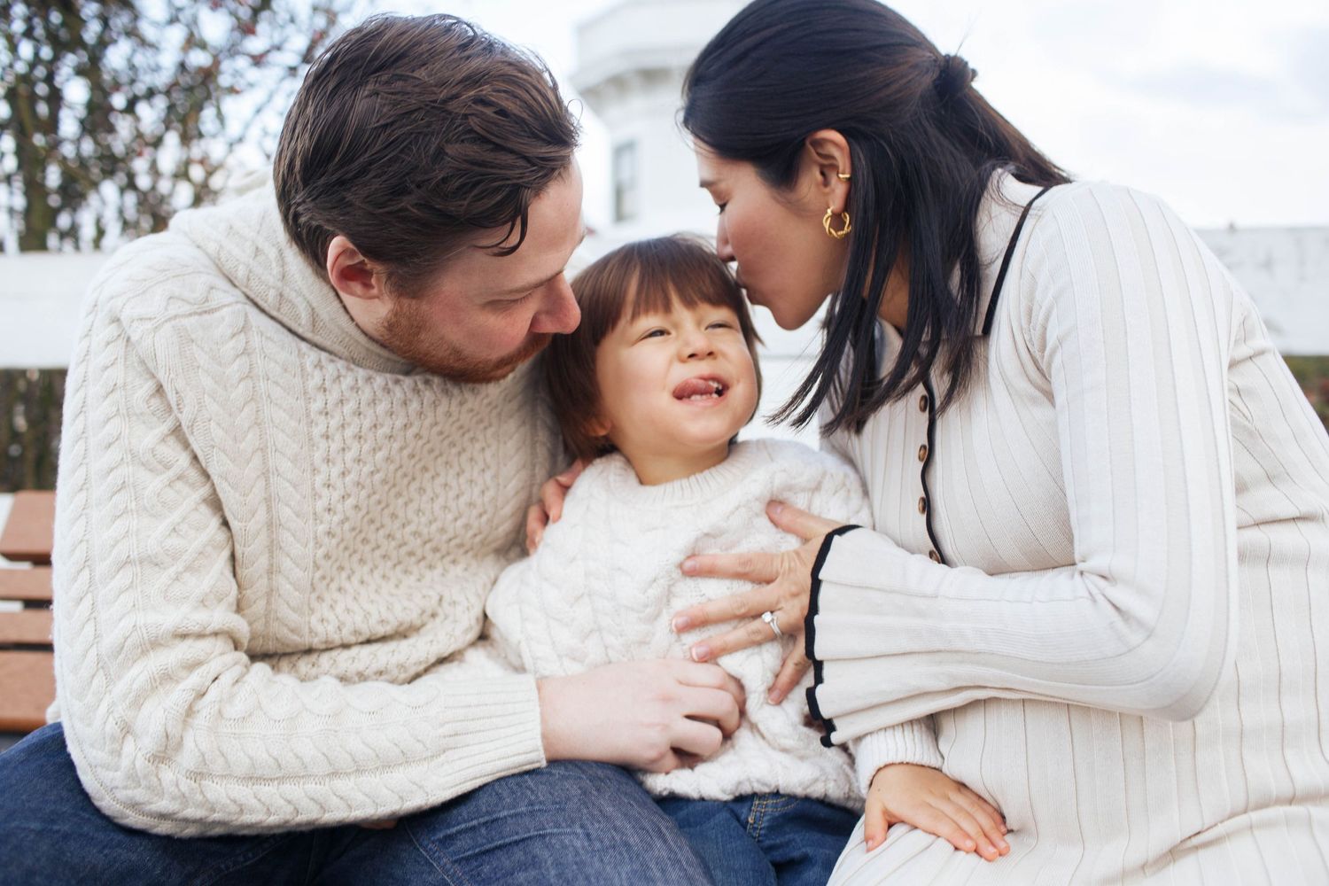 Everett WA family photographer: a mother and father hug their son at a family photo session in Mukilteo WA