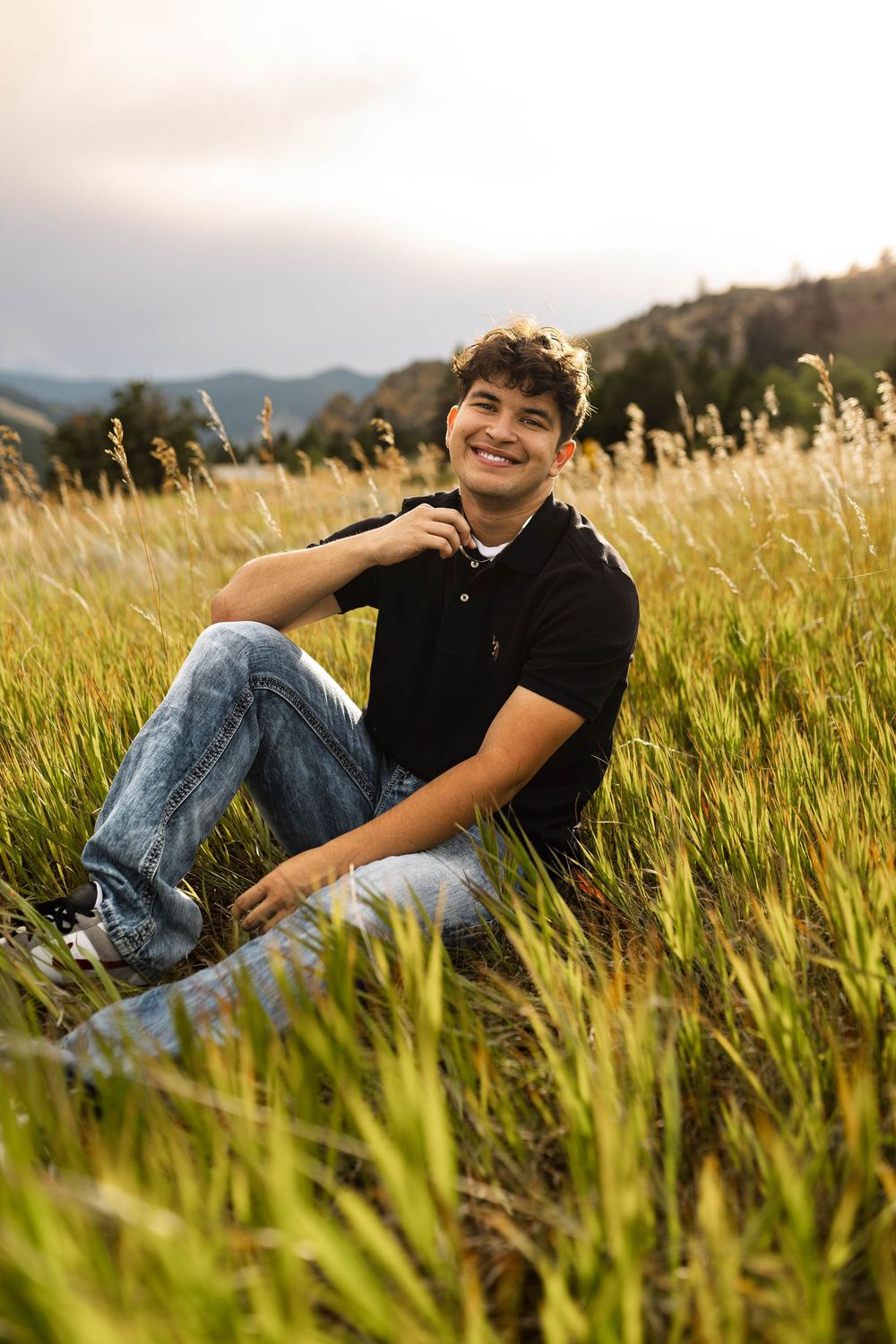 Person relaxing in tall grass field during golden hour with mountains in background, captured in multiple poses.