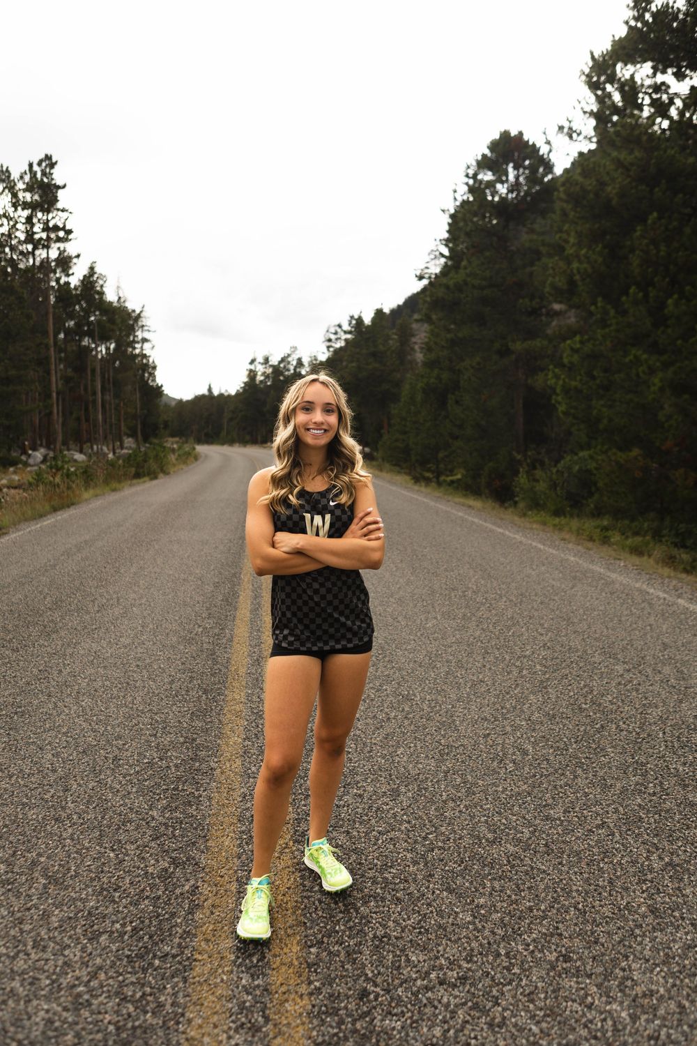 A sequence of photos showing a person stretching and warming up on an empty rural road surrounded by pine trees.