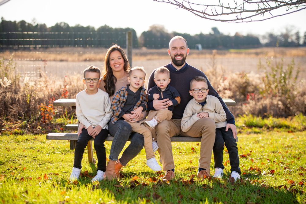 Family portrait series taken in autumn with fall foliage and golden sunlight.