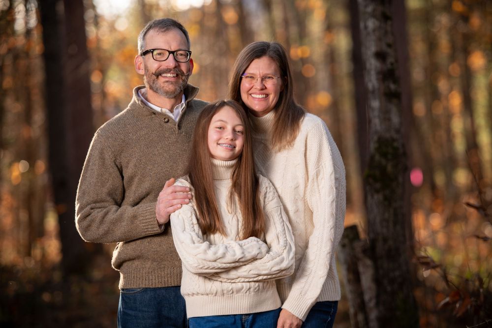 Candid family photos taken in a wooded setting during golden hour.