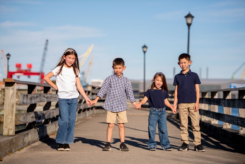 Group photos taken on a seaside boardwalk with ocean views.