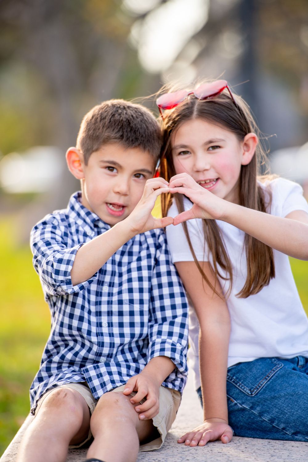 Close-up photos of children having fun and making silly faces together outdoors.