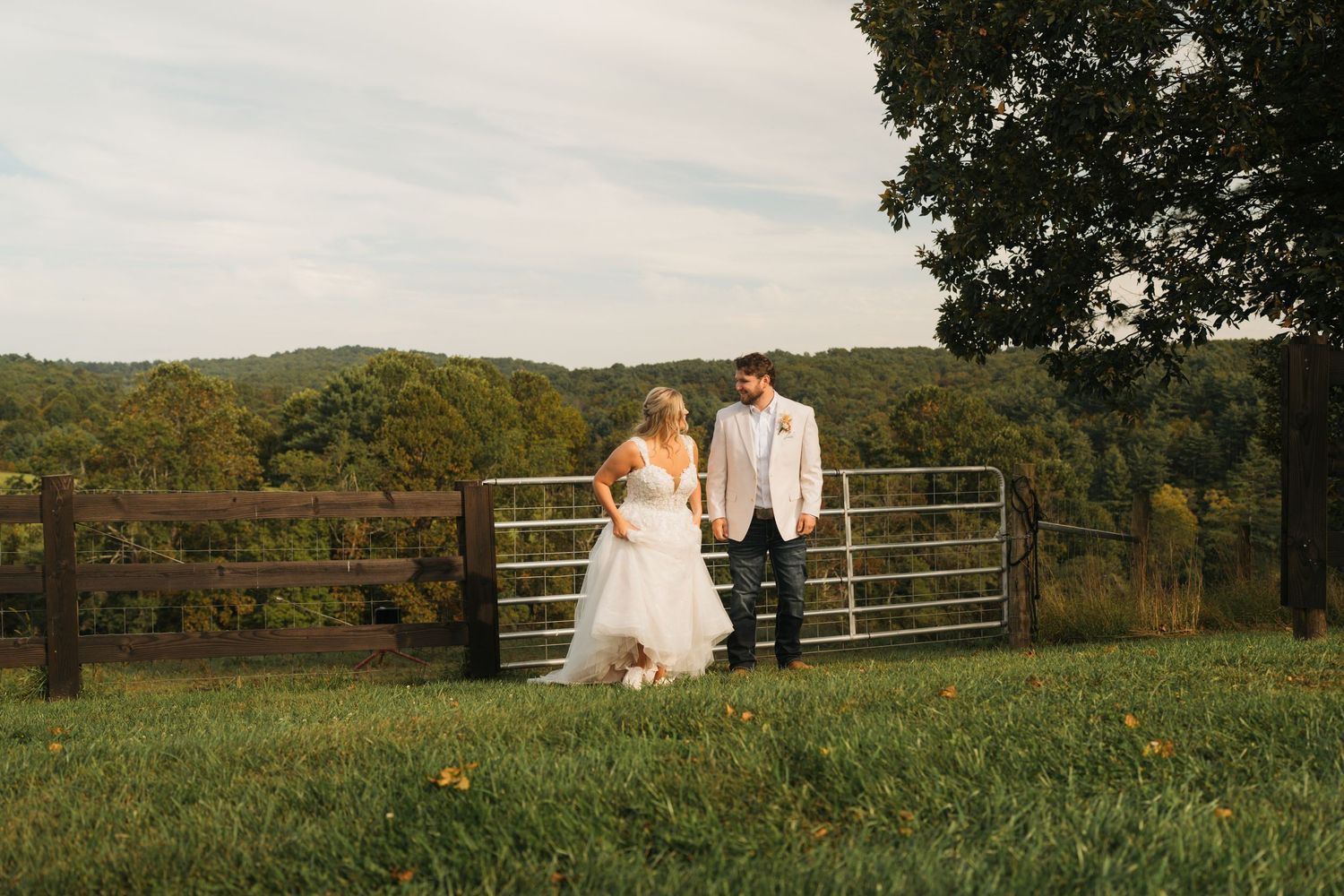 Wedding ceremony in an autumn mountain setting with guests throwing confetti.