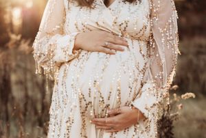 Close-up maternity photos showing details of sparkly white dress in warm evening light.