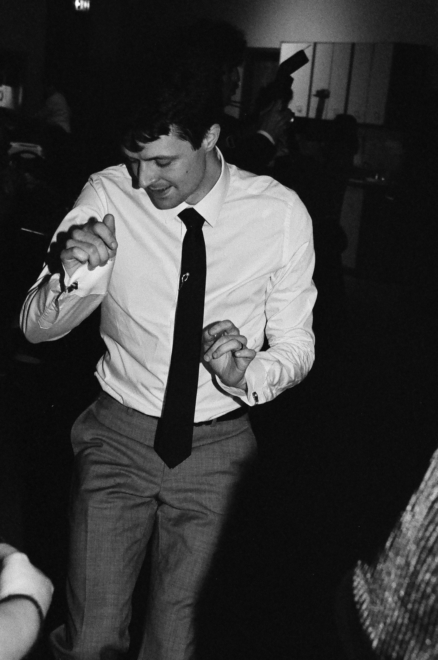 A three-panel black and white photo sequence showing someone dancing in formal attire at a festive event. Flying Camera Studio, Seattle, Wa