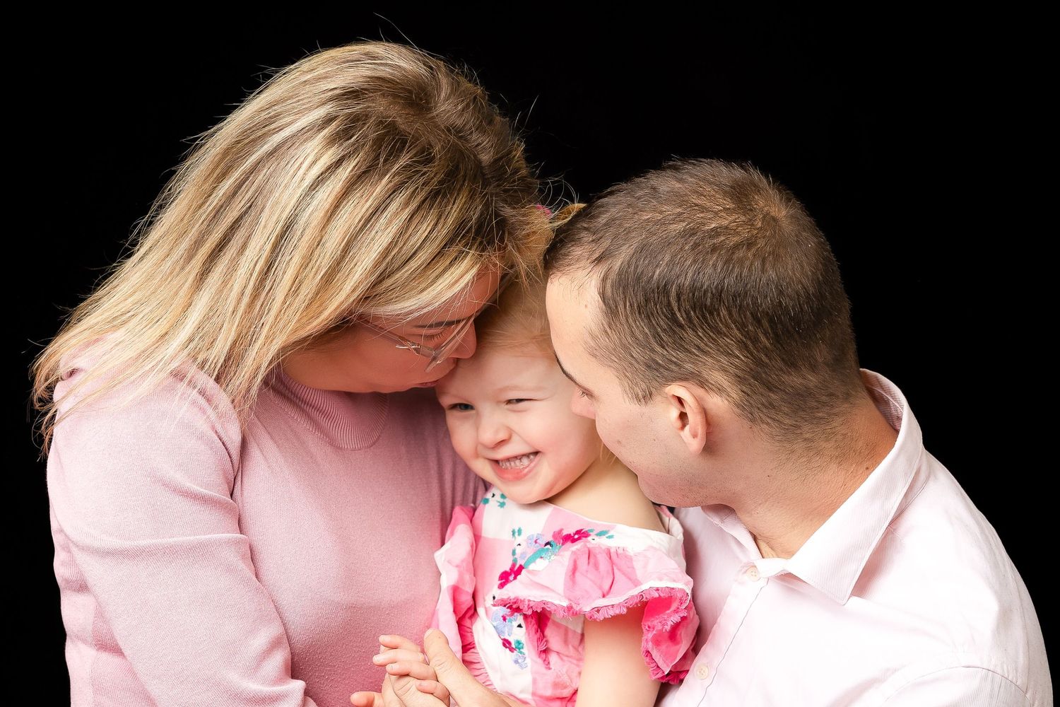 family photo in studio on black background