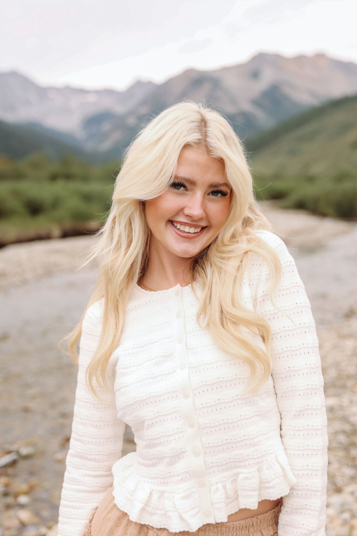 Candid Aspen senior photography capturing natural laughter in the fall foliage
