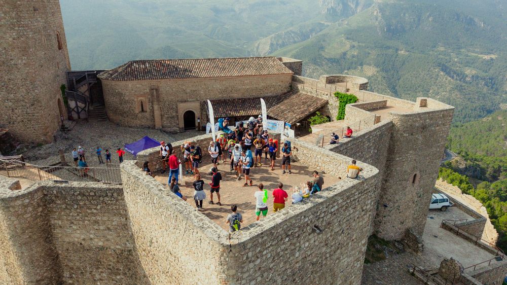 Panoramic view of the Great Wall of China stretching across mountainous terrain with visitors exploring the historic structure.