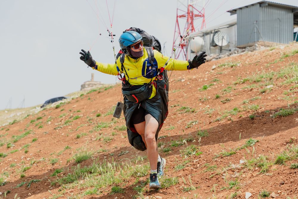 A sequence of photos showing a person hiking up a steep red dirt slope with a backpack and hiking gear.